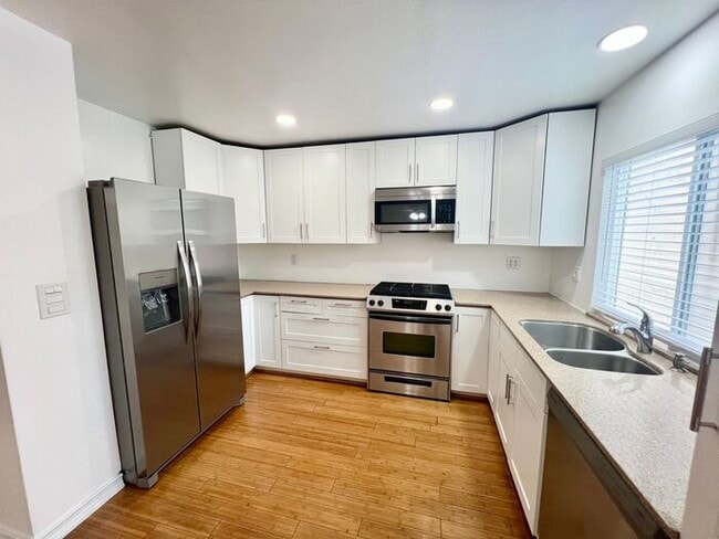Building Photo - Stunning 4BR Townhome with Hardwood Floors, Private Patio, Community Pool & 2-Car Garage!