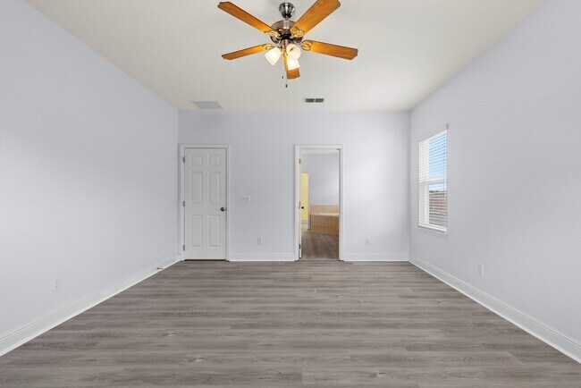Building Photo - Spacious 6-Bedroom Home Near Lake Nona | 3-Car Garage + Tesla Charger