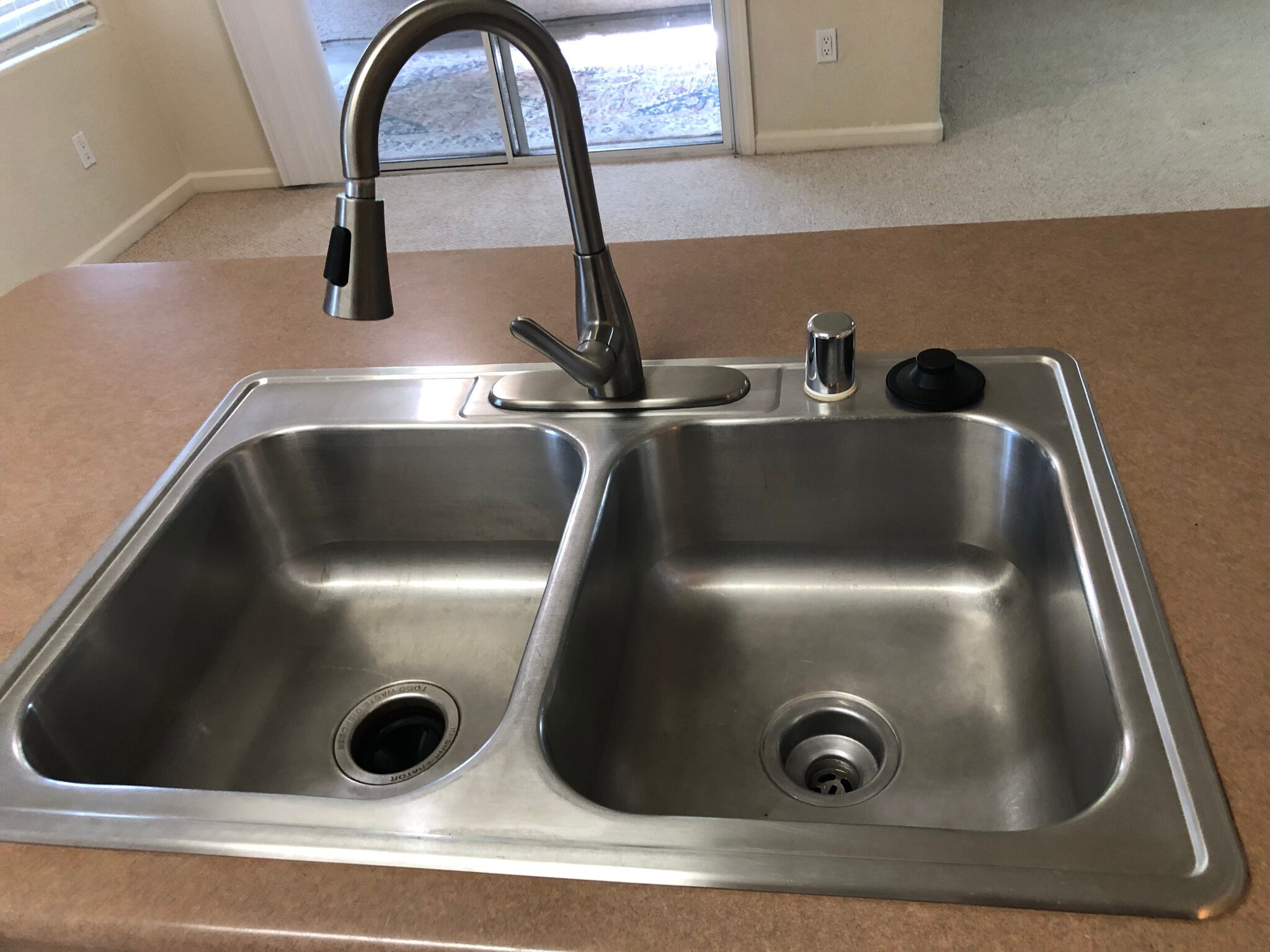 Stainless duel tub kitchen sink w/adjustable spray and new garbage disposal - 10001 Woodcreek Oaks Blvd
