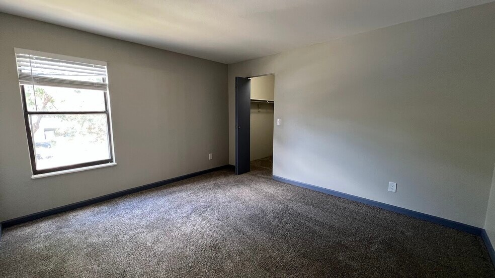 Bedroom window overlooking the parking lot. - 12063 E Harvard Ave