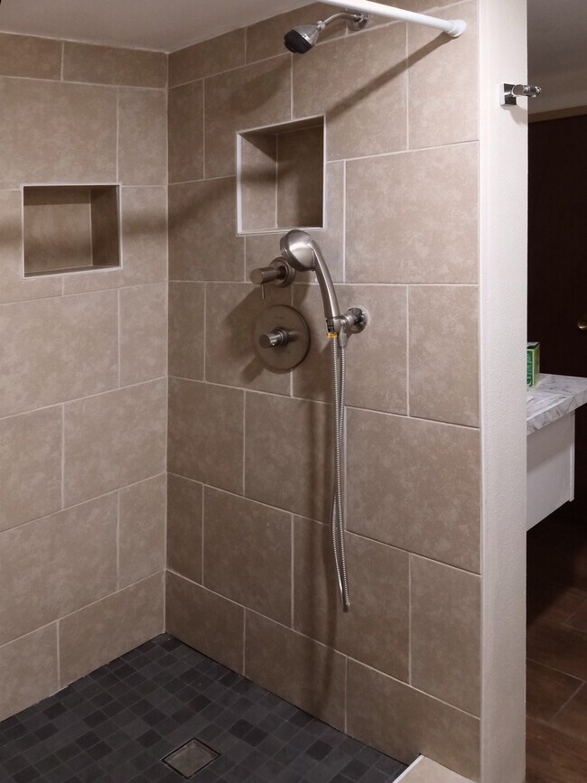 Tiled shower with separate temperature and volume control and hand shower. - 8008 149th St NW