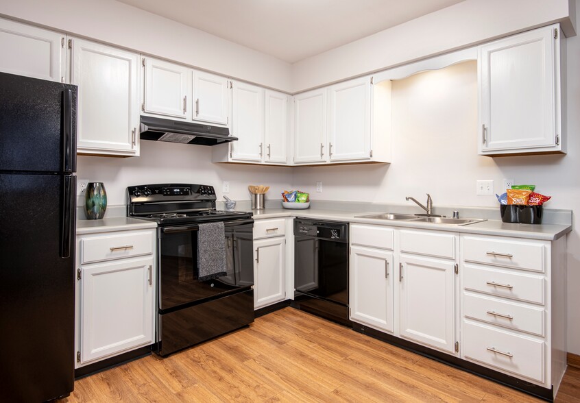 Kitchen with black appliance package - Preserve West