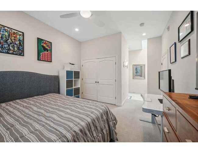 View of master bedroom closet with large organizing unit, entrance to ensuite bathroom - 3125 Inglewood Ave S