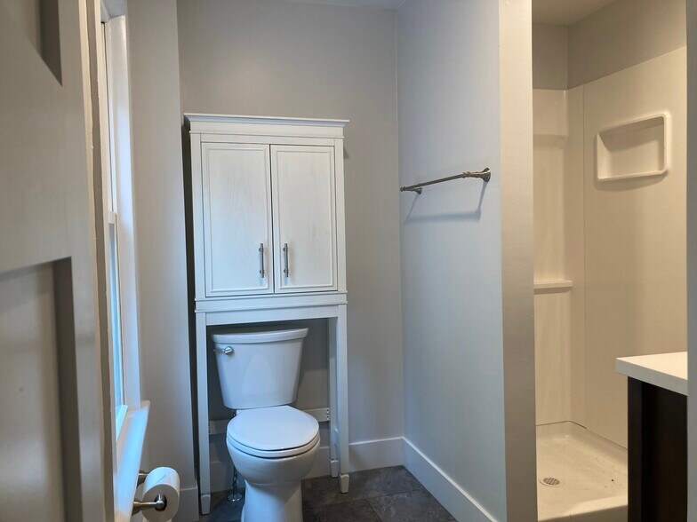 All new bathroom with over toilet storage, 2 towel racks, hooks on door and room for laundry basket. - 35 Main St