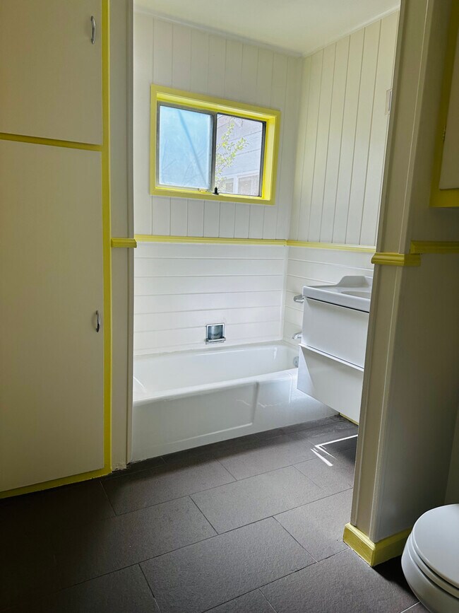 Bright light sifts into the bathroom, which has lots of storage! - 924 Nowita Pl