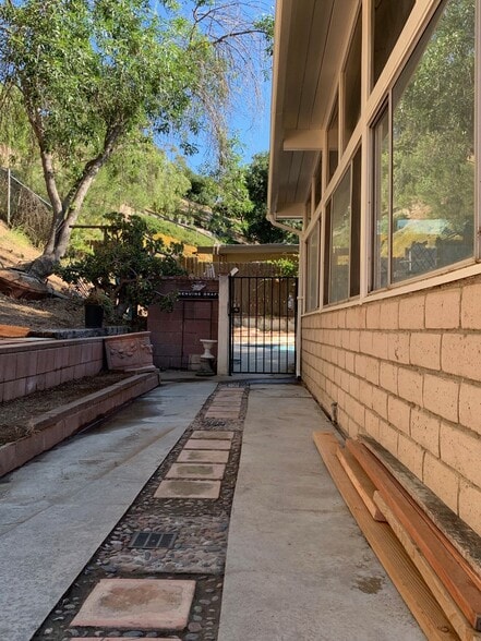 Walkway to hill area and sunroom - 10458 Pearson Pl