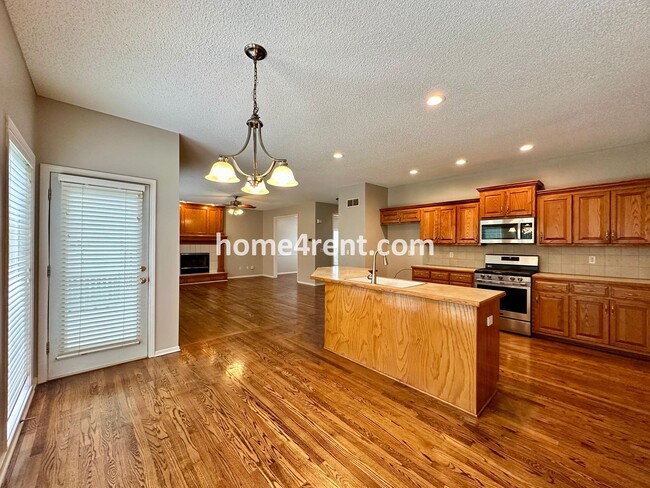 Building Photo - Beautiful Four-Bedroom Home with Three Car Garage, Wood Floors, Finished Basement and a Fenced Ya...
