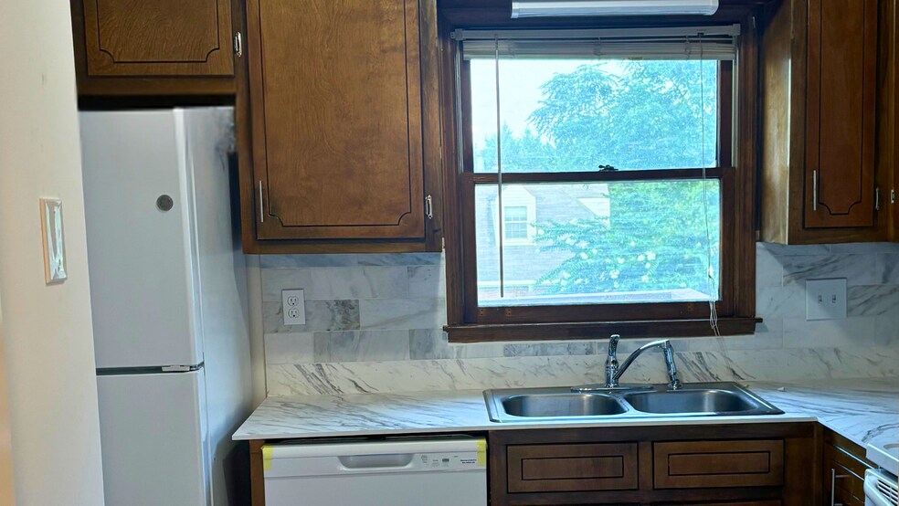 Kitchen with wood cabinets and window lighting. - 905 Park Pl NE