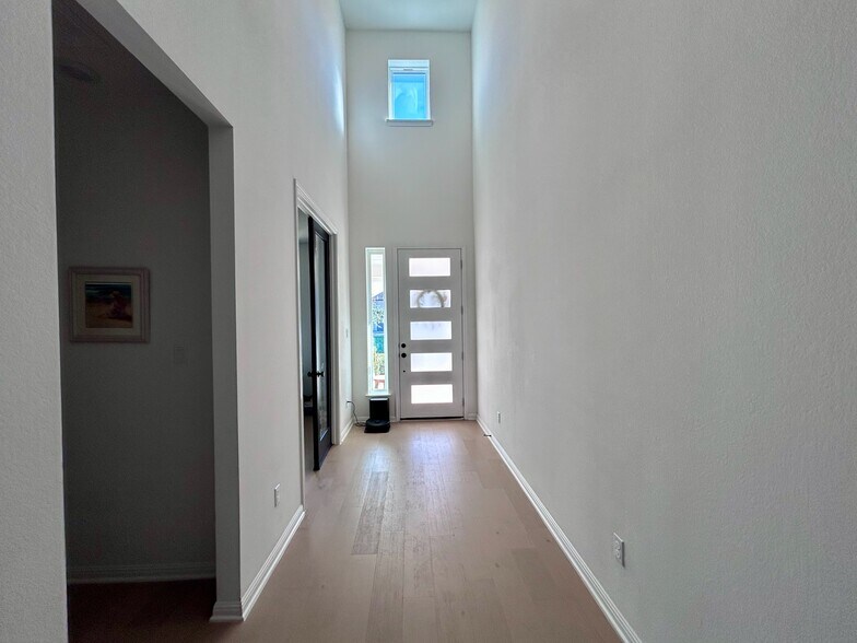 Impressive entryway with soaring ceilings and abundant natural light. - 517 Moonlit Stream Pass