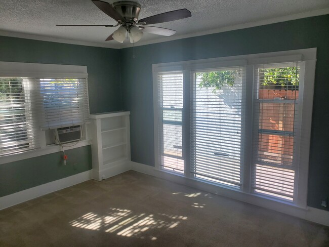 Front room with Air conditioner and bookshelf. - 1666 Locust St