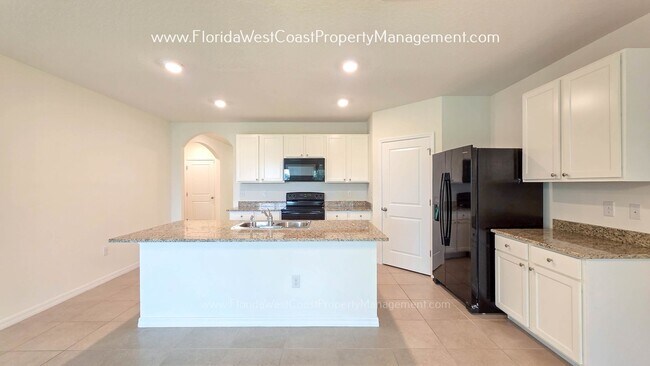 Building Photo - MOVE IN READY ! 4 BEDROOM/2 BATH! TILE- LVP THROUGHOUT! LAWN MOWING INCLUDED!