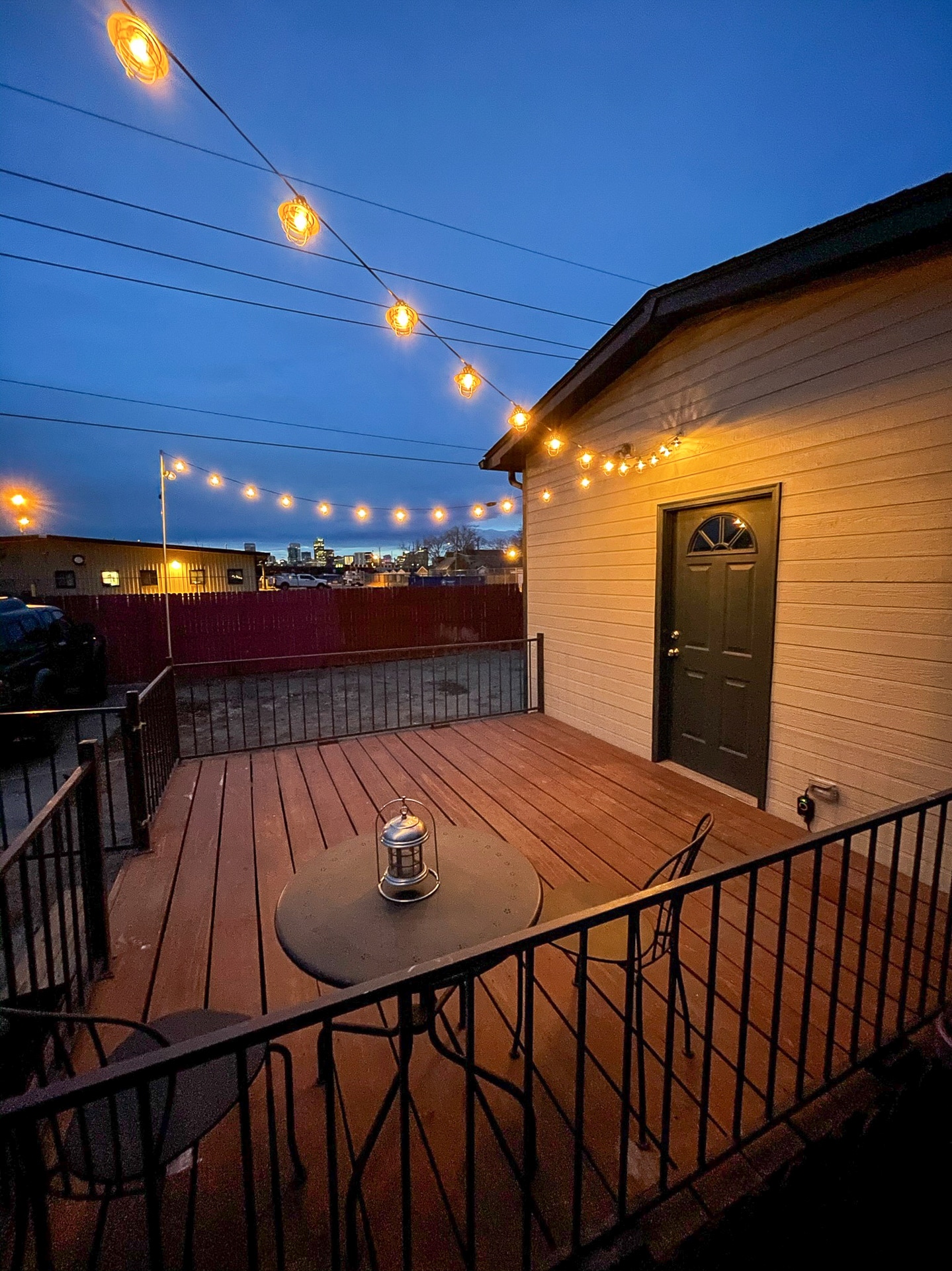 Impressive city views from deck with string lights, great for entertaining. - 4404 Sherman St