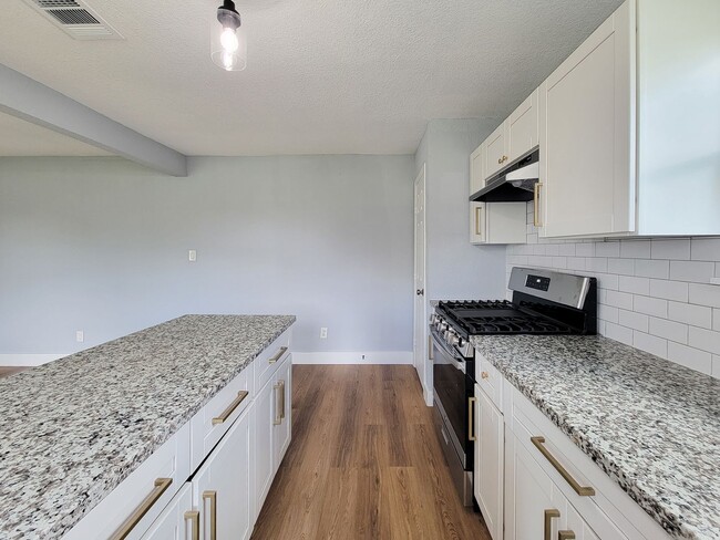 Building Photo - This beautifully updated 4-bedroom home is just under two miles from Highway 288 and Loop 610, ma...