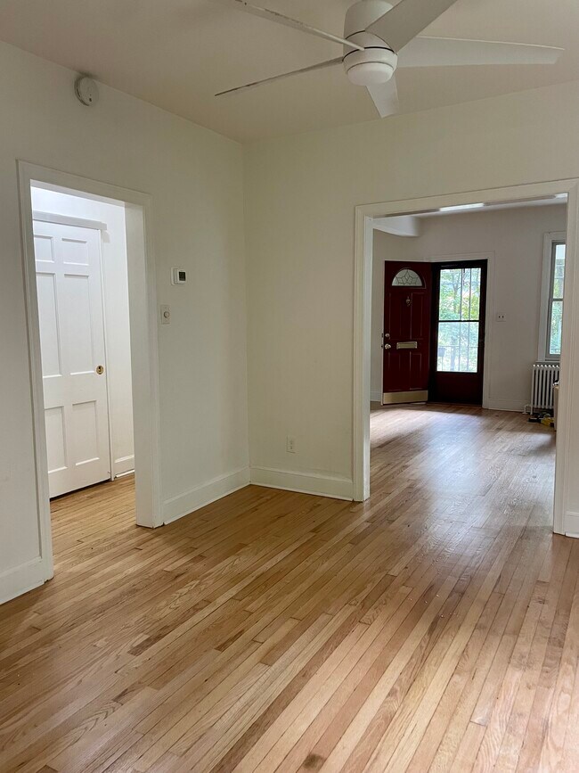 View from kitchen doorway to dining area. Barn door seen in hallway opens to the bathroom - 6027 Ridge Dr