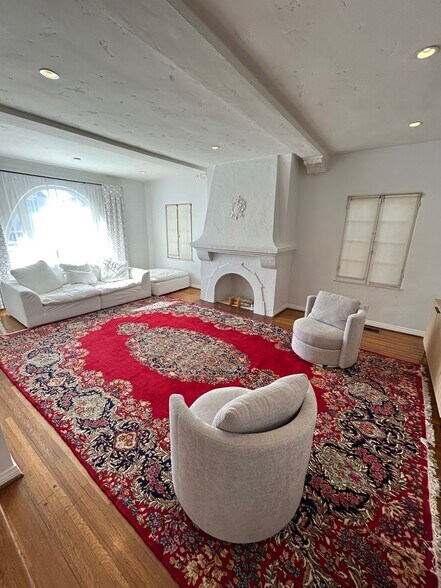 Large living room with multiple windows - 8673 W Olympic Blvd