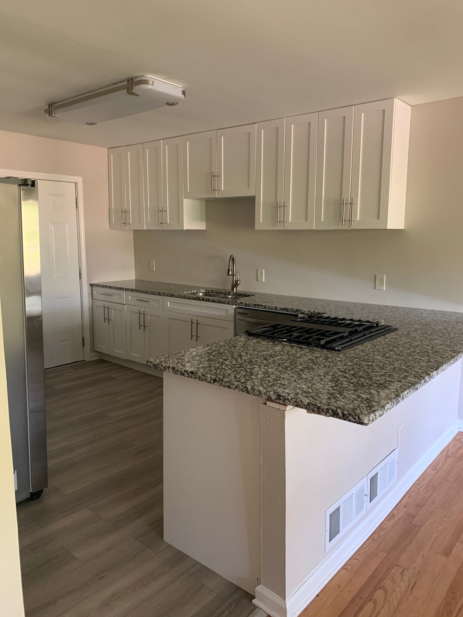 Spacious, open kitchen recently renovated with stainless appliances. Room for bar stools. - 561 Northern Ave