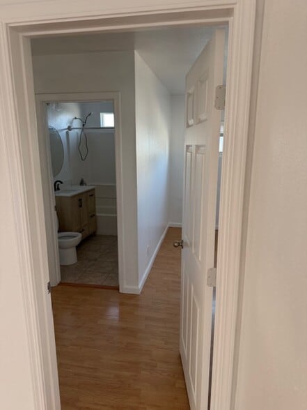large bedroom with connected bathroom. - 4626 E 7th St