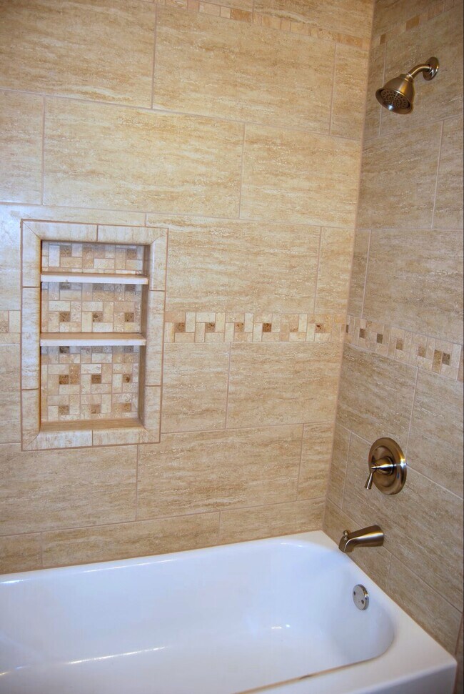 Natural Stone, tiled tub and shower combination. - 2923 Arthur St NE