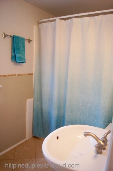 Bathroom with shower and tub. - 629 Hillpine Dr NE