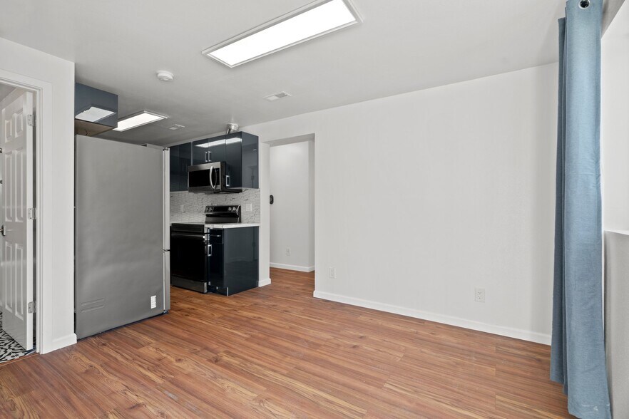 Open-concept renovated modern kitchen with all new stainless steel appliances - 411 124th St S