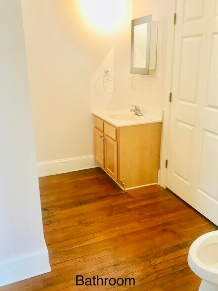 Full bathroom with tub, curved glass enclosure, and plenty of built-in storage space. - 1937 Fairfield Dr