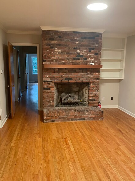 Den with brick fireplace and mantel - 2112 Kilburn Rd