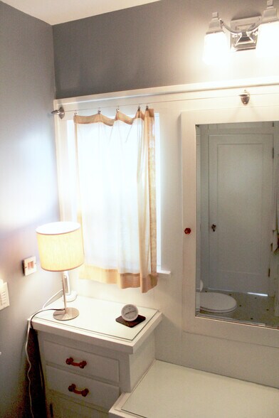 Period correct Bathroom. From hex tiles to deep cast iron soaker tub and incredible built in vanity. - 2635 NE 30th Ave