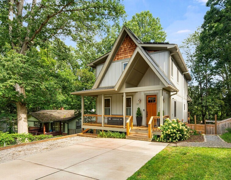 Front of the house with gravel walking path to the gated backyard. - 33 Rex Dr