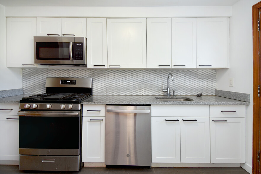 Completely renovated kitchen with modern stainless steel appliances, and quartz countertops - 31 Marylea Ave