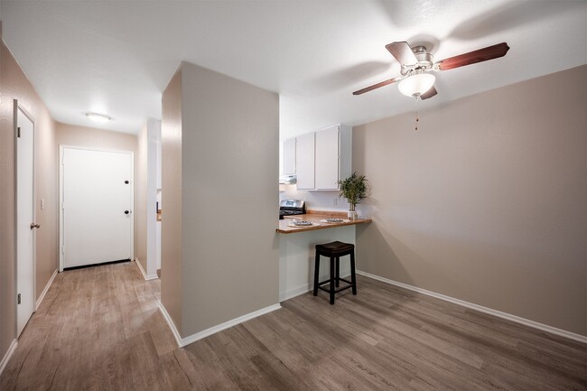 living room and kitchen with ceiling fan - Oak Park Apartments