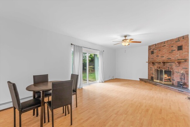 Spacious recreational room with a wood burning fireplace. It also has access to the backyard. - 45 High St