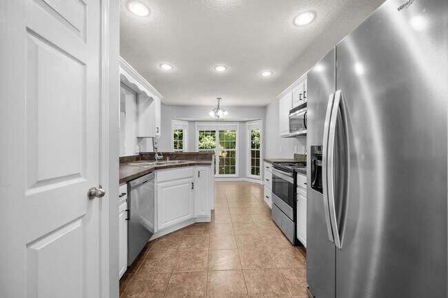 Building Photo - Stunning Stone Fireplace • Finished Basement • Fenced Yard