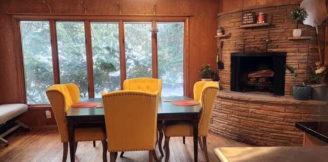 Sun-filled bonus room featuring a cozy fireplace—ideal for relaxing or entertaining. - 2923 Arthur St NE