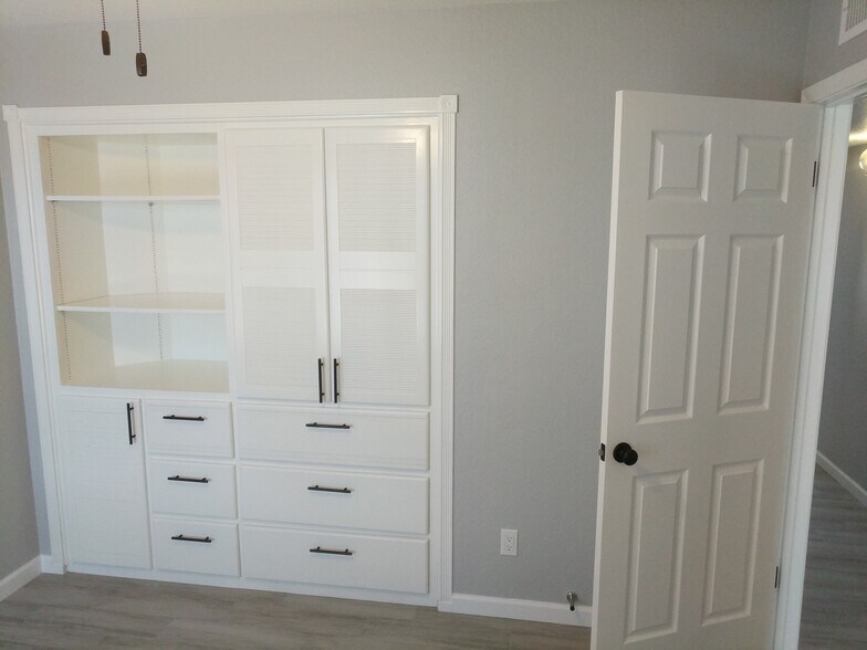 Room 1, with custom built in cabinet and dresser. East Wall - 14101 N 78th Dr