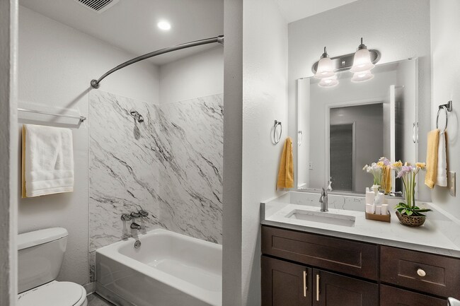 Experience tranquility in this elegantly designed bathroom with modern amenities. - University Crossing Apartments