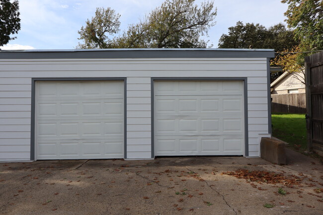 Newly painted separate garage doors with locks on each door (not pictured) and handles for easy rais - 13559 Red Fern Ln