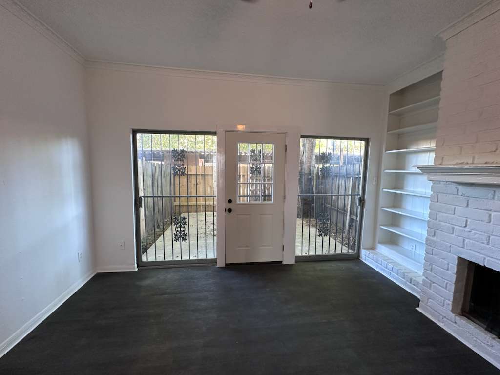 Living area with oversized windows and direct access to the private patio and garage. - 7700 Creekbend Dr