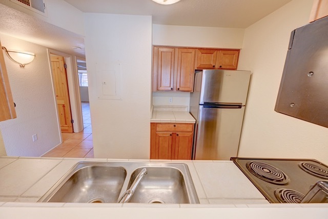 Unit 813--Kitchen cabinets enhanced by pantry - 2210 Miguel Chavez Rd