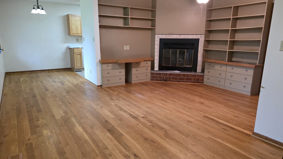 Den with wood floor and fireplace - 620 East St S