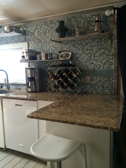 Granite counters and tile backsplash. Island seating area. - 3000 Clarcona Road