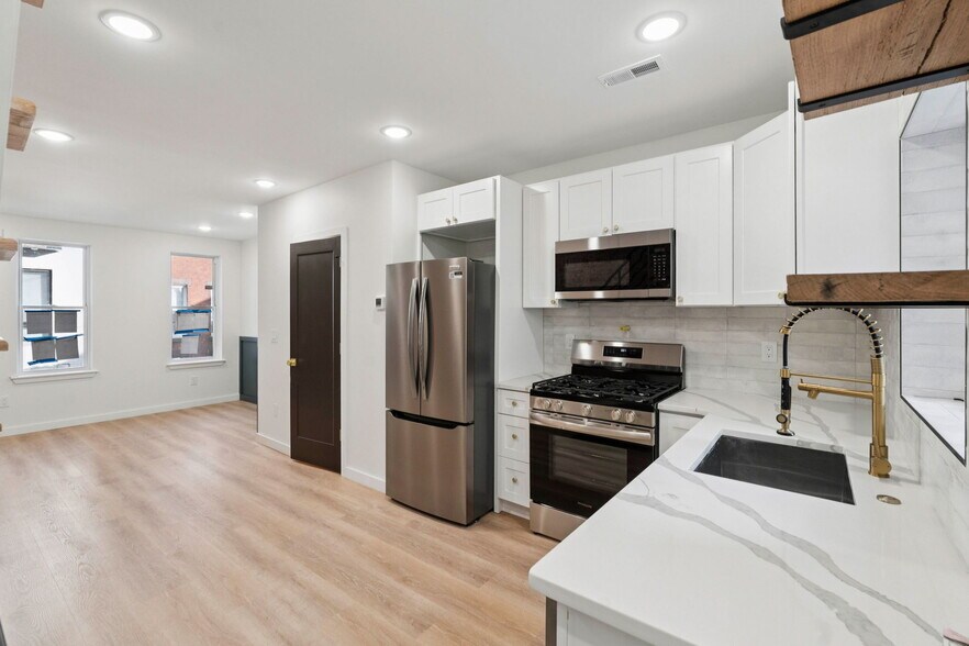 Kitchen with stone countertop and stainless steel appliances - 1544 S Bambrey St