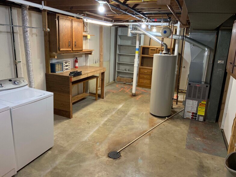 Unfinished basement utility, storage room, work bench - 11934 Holly Brook Dr