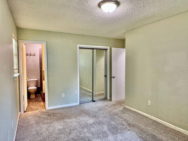 Building Photo - Cozy Meets Spacious: 4BR/2BA with Bonus Den & Patio