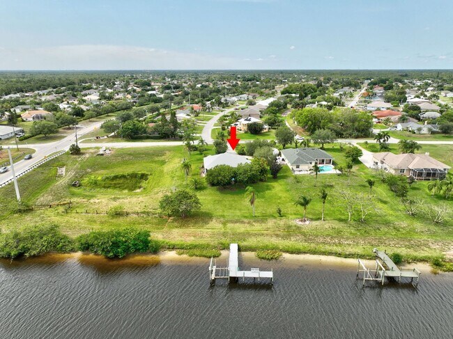 Building Photo - A BOATER'S PARADISE WITH THIS STUNNING 3 BEDROOM, 2 BATH WATERFRONT POOL HOME W/DOCK & BOAT LIFT ...