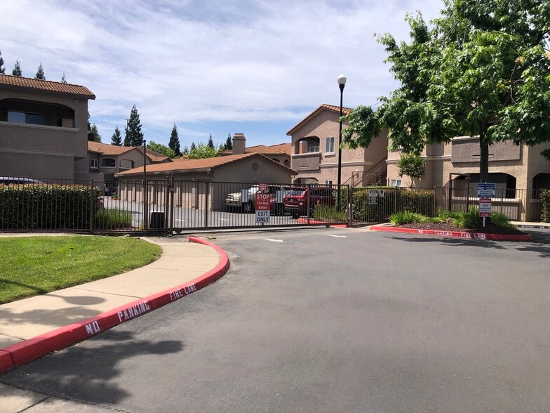 Property exit gate. - 10001 Woodcreek Oaks Blvd