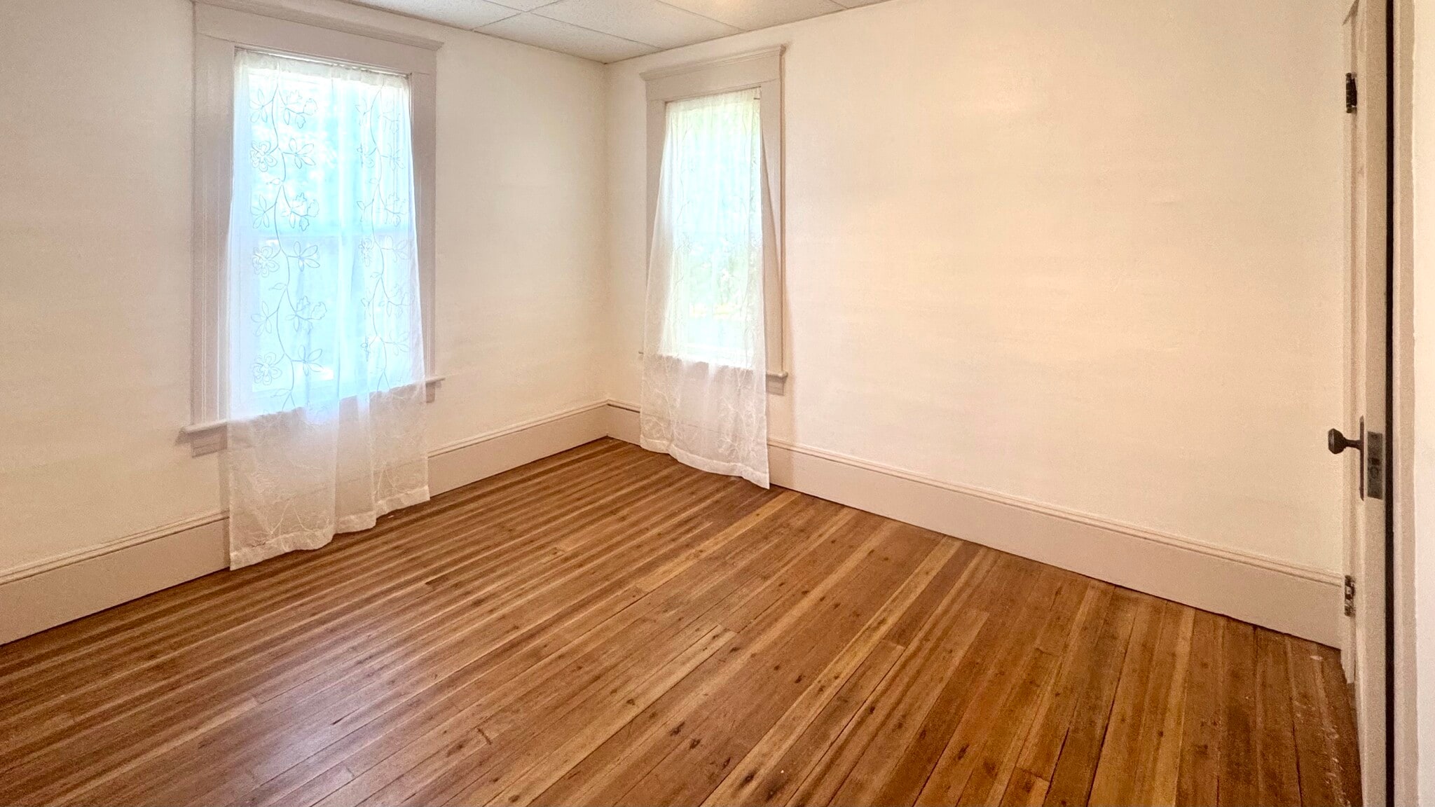 Bedroom 1 has 2 windows and 1 closet. - 98 Maple St