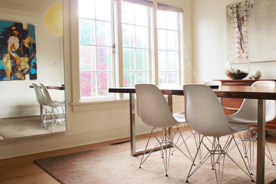 Light filled dining room with tall casement windows and translucent cellular window coverings throughout. - 2635 NE 30th Ave