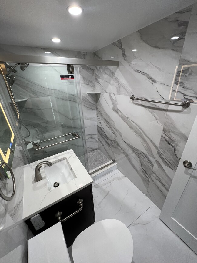 Spa-like walk-in shower with marble flooring - 730 24th St NW