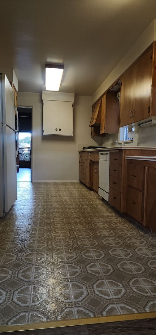 Building Photo - This is a spacious house featuring four bedrooms and two bathrooms, along with a two-car garage.