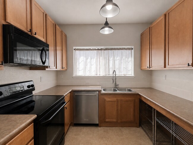 Building Photo - Spacious 2-Bedroom Condo with Garage, Fireplace, Pool & Most Included Utilities